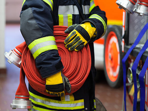 firefighter wearing a rolled fire hose